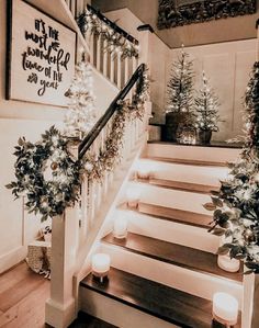 stairs decorated with christmas lights and greenery for the holiday decorations on each handrail