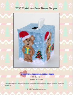 a cross stitch tissue box with a teddy bear on it and a santa claus hat