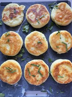 some food that is sitting on a blue tray and ready to be cooked in the oven