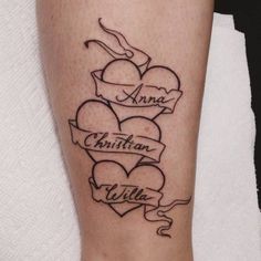 a tattoo on the leg of a woman with two hearts and an inscription that says ann, christian, willa