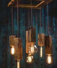 some lights are hanging from the ceiling with wood planks and glass jars on them