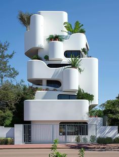 a tall white building with lots of plants on it's balconies and windows