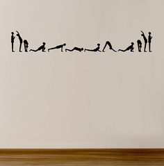 there is a wall decal with people doing yoga on it in the shape of a line