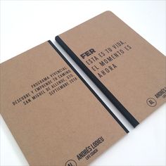 two brown notebooks sitting on top of each other