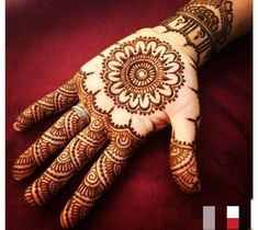 a henna on someone's hand with intricate designs