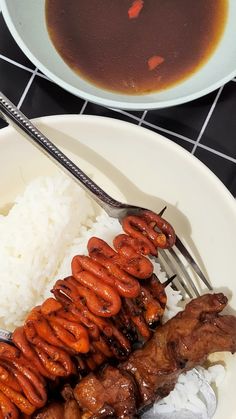 a white plate topped with meat and rice