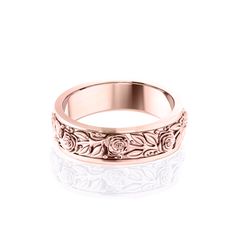 a rose engraved wedding ring on a white background