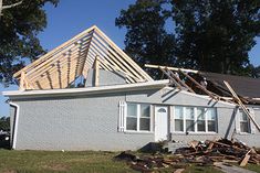 a house that is under construction with the roof ripped off