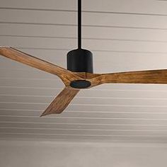 a ceiling fan that is hanging from the ceiling in a room with white walls and ceilings