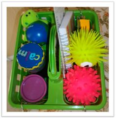 a green container filled with toys on top of a table