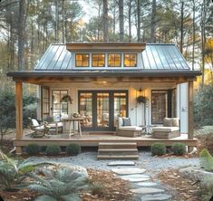 a small house in the woods surrounded by trees