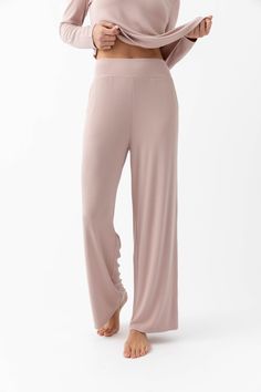 The one downside of our Women’s Bamboo Rib-Knit Pant is you’ll never want to take them off. The good news is you don’t have to. Featuring a breathable bamboo viscose to prevent night sweats, this seasonless lounge pant has a luxuriously soft finish, sophisticated silhouette, and forgiving stretch that flatters every form. Includes side pockets, a wide elastic waistband, and a straight leg for all-day comfort. Wear these rib-knit pants with the Women’s Rib-Knit V-Neck Tank for a matching loungewear set or with a formal top and heels to dress it up. Women's Bamboo Viscose Rib-Knit Lounge Pants in Ivory (Size: Large) - Cozy Earth Cute Casual Lounge Outfits, Massage Outfits For Women, Women’s Loungewear, Loose Loungewear, Matching Loungewear Set, Bamboo Pants, Comfy Lounge Wear, Anthropologie Christmas, Womens Loungewear Sets