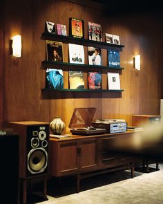 an entertainment center with speakers and books on the wall