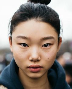 a woman with an upside down nose piercing