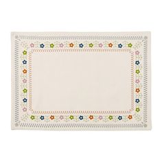 a white place mat with flowers and leaves on the border, in front of a white background