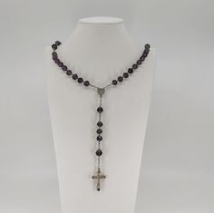 A beautiful vintage French rosary, in good condition, comes with nice solid silver cross crucifix. Rosary measures approx. 50 cm (20 inch) in length and has nice purple glass faceted beads which are all intact and very pretty. The connector is with Mother Mary, this interesting rosary would make a nice gift for someone special or a collector. Box on photos is NOT included! A stunning religious jewelry shop well worth a visit ... https://www.etsy.com/shop/100saints. PLEASE LOOK AT THE PICTURES, T Spiritual Crucifix Necklace With 8mm Beads, Gift Rosary With Polished Beads And Cross, Gift Rosary With Polished Beads, Spiritual Cross Necklace With Polished Beads, St Benedict Medal, St Peter And Paul, Jesus Necklace, Benedict Medal, St Benedict