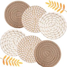 four round placemats with leaves on them