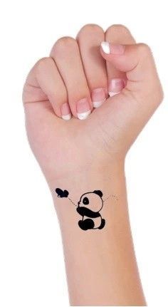 a small panda bear tattoo on the wrist