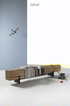 an airplane flying over a bookshelf with magazines on the bottom and below it