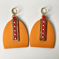 Just imagine... you've spent the day at the beach, the sun's warmed your skin, there's a cool drink in your hand, you're relaxed all the way down to your toes, and the sun is just starting to set at the horizon. These earrings are inspired the splendor of a magical vacation sunset. Two shades of vivacious orange leather, combined with gold leather and 5 hand-sewn sunstone beads, to make these resort-ready earrings. The earrings secure to pierced ears with hinged lever-back ear wires in gold-plat Single Earring For Everyday Summer Wear, Orange Summer Earrings For Vacation, Everyday Summer Pierced Earrings, Summer Everyday Pierced Earrings, Nickel-free Red Earrings For The Beach, Orange Earrings For Summer Gifting, Red Teardrop Earrings For The Beach, Red Teardrop Earrings For Beach, Orange Earrings For Everyday Summer Wear