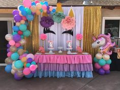 a unicorn themed party with balloons and decorations