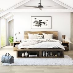 a bedroom with white walls and wooden furniture in the center, along with a large window