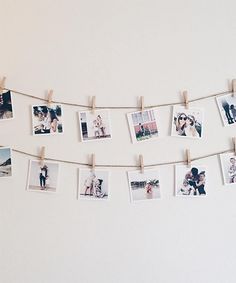 several polaroid photos hanging on a clothes line