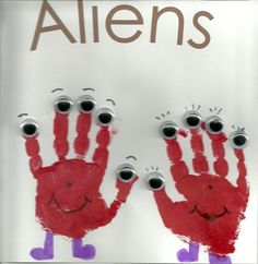 two handprints with eyes and hands are on a sign that says, aliens