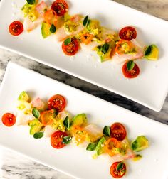 two white plates topped with different types of food