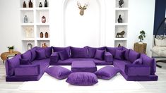 a living room filled with lots of purple furniture