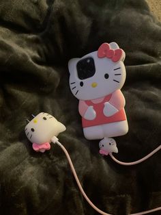 the hello kitty phone case is plugged in and has a mouse attached to it