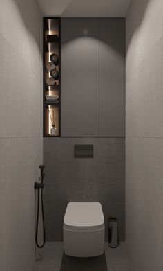 a bathroom with a white toilet sitting next to a wall mounted faucet in it