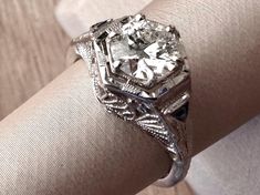 a close up of a ring on a person's arm with a diamond in the center