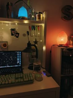 a laptop computer sitting on top of a desk next to a keyboard and mouse in front of a book shelf