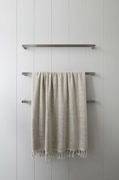 a towel hanging on the side of a white wall