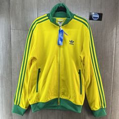 Adidas Originals Fb Nations Beckenbauer Track Top Brasil Condition: New With Tags Color: Yellow / Green Sizes Available: Men's Small / Medium Style Code: Hk7410 Regular Fit Full Zip With Stand-Up Collar52% Cotton, 48% Recycled Polyester Doubleknit Front Zip Pockets Ribbed Cuffs And Hem Yarn Contains 50% Parley Ocean Plastic This Garment Contains A Minimum Of 40% Recycled Material In Total Adidas Green Winter Track Jacket, Green Adidas Winter Track Jacket, Winter Adidas Green Track Jacket, Adidas Green Track Jacket For Spring, Adidas Yellow Outerwear For Streetwear, Yellow Long Sleeve Track Jacket For Winter, Adidas Yellow Long Sleeve Outerwear, Yellow Track Jacket For Spring Streetwear, Spring Sports Yellow Outerwear