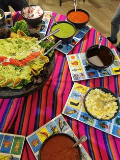 a table topped with lots of different foods and condiments on top of it