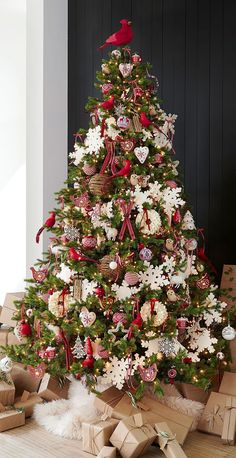 a decorated christmas tree with presents under it