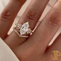 a woman's hand with a ring on it and a diamond in the middle