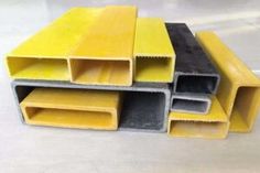 yellow and black plastic pipes stacked on top of each other in different sizes, shapes and colors