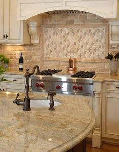 a kitchen with an oven, sink and counter tops in it's center island