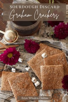 graham crackers with marshmallows on top and flowers in the foreground