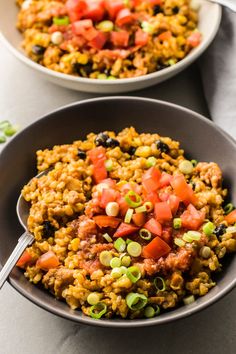 two bowls filled with rice and vegetables on top of a table