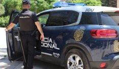 a police officer standing next to his patrol car with its doors open and the door opened