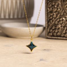 Chrysocolla Star Gold Necklace 14k Gold Filled Cable chain - 4 point star, bezel stone set, unique jewelry gifts for mom, daughter, niece. Stone: Genuine Chrysocolla Please note due to nature of our genuine stones no two are alike and the ones you will receive will vary slightly from the ones pictured in the photos. Bezel: Vermeil Gold Chain: 14k Gold Filled, 16 to 18 inch adjustable, 1.3mm cable, Spring Ring Clasp Gemstone: 13mm wide x 13mm height About "Gold Filled Jewelry": Also called rolled-gold. These jewelry items are not actually filled with gold. They are made of a base metal covered by sheets of gold in a mechanical bonding process. Effectively a thick coat of gold: the industry standard for the gold content is 5% or 1/20 of the total weight. Made with 14k gold, it is hard wearin Celestial Jewelry With Bezel Setting For Gift, Star Gold Necklace, 4 Point Star, Gold Gemstone Necklace, Unique Jewelry Gifts, Mom Daughter, Gold Filled Jewelry, Necklace Earring Set, Stone Settings