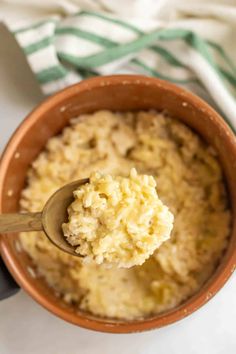 a spoon full of oatmeal sitting in a bowl