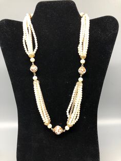 This is a beautiful 7 strand faux pearl necklace . the necklace is adjustable 20" - 22" long and has a nice faux pearl closure, the beads are plastic. within the 6 strands has a metal chain. the beads are resin, the necklace is in great shape. Made in Japan nice pre owned, estate sale find. Measures 2o"-22" Email me with any questions Luxury Vintage Single Strand Beaded Necklace, Multi-strand Pearl Drop Necklace, Beaded Multi-strand Pearl Layered Necklace, Formal Adjustable Multi-strand Necklace, Vintage Adjustable Beaded Pearl Necklace, Cream Pearl Multi-strand Necklace, Cream Multi-strand Pearl Necklaces, Formal Multi-strand Costume Jewelry Necklaces, Cream Multi-strand Pearl Necklace