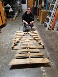 a man is working on some wooden planks