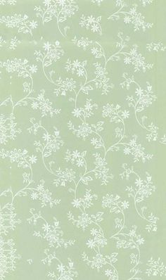 a green wallpaper with white flowers on it