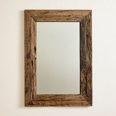 a wooden mirror hanging on the wall